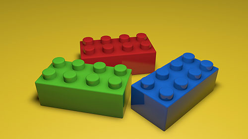 A 3D render of assorted Lego bricks. One is green, one is blue, and one is red.